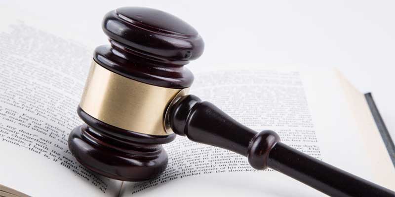 Gavel sitting on top of an open book